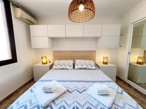 a bedroom with a large bed with two towels at Marina View Apartment in Fuengirola