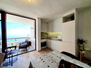 a kitchen and living room with a view of the ocean at Marina View Apartment in Fuengirola