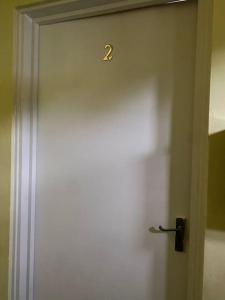 a white door with the number two on it at Eremue Court Hideaway Yarmouth IOW in Yarmouth