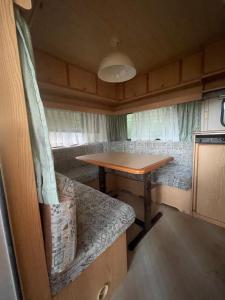 a dining room with a table in a trailer at Camping Erika in Paestum