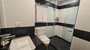 a bathroom with a toilet and a sink and a shower at d'primahotel Lagoi Bintan in Lagoi
