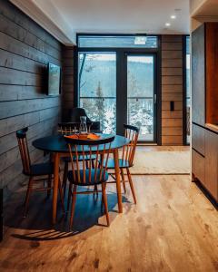 a dining room with a table and chairs and a window at Kurula's Resort in Pyhätunturi