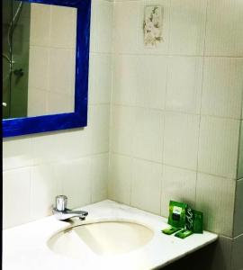 a bathroom with a sink and a mirror at POUSADA ARKAN BEACH in Saquarema