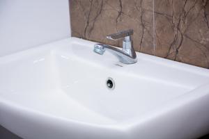 a white sink with a faucet in a bathroom at Turtle Paradise in Tangalle +147 photos