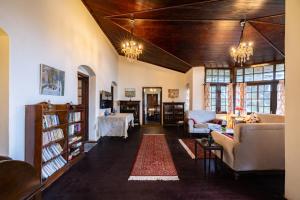 a living room with a couch and a table at amã Stays & Trails - Wayside Villa, Kurseong in Karsiyang