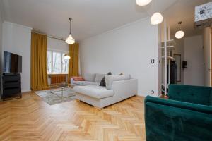 a living room with a couch and a table at Apartment Peegel in city center free parking in Tallinn