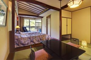 Postel nebo postele na pokoji v ubytování Ryokan Fushioukaku + 37 fotografií