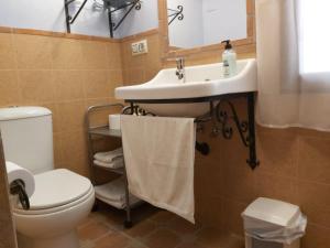 a bathroom with a sink and a toilet at Apartamentos Tío José María in Hinojares