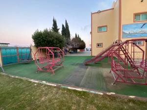 a playground with a slide in a yard at منتجع وردة الهدا in Al Hada