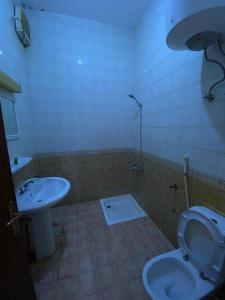 a bathroom with a toilet and a sink at منتجع وردة الهدا in Al Hada
