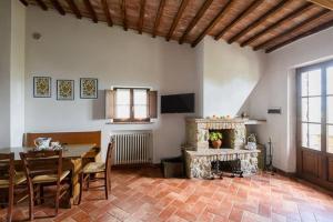 a living room with a table and a fireplace at Relax Palazzo Monaci in Asciano
