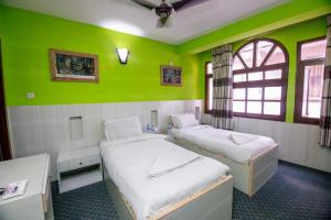 Postel nebo postele na pokoji v ubytování Hotel Pomelo House Inn