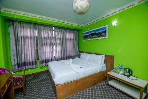 Postel nebo postele na pokoji v ubytování Hotel Pomelo House Inn