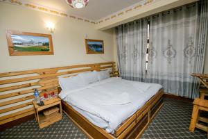 Postel nebo postele na pokoji v ubytování Hotel Pomelo House Inn
