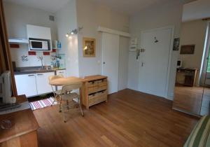 a kitchen with a desk and a table in a room at Studio near UNESCO - Invalides in Paris