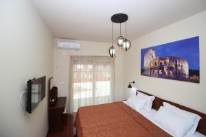 a bedroom with a bed and a large window at Hotel INTERNATIONAL Ohrid in Ohrid