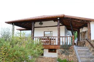 a house with a porch and stairs in front of it at Quintinha d´Amélia in Celorico de Basto