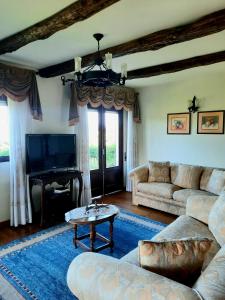 a living room with a couch and a table at Quintinha d´Amélia in Celorico de Basto