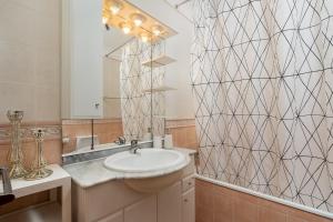 a bathroom with a sink and a mirror at Sea La Vie Beach & Golf Apartment in Lagos