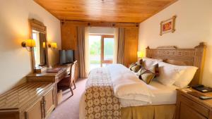 a hotel room with a large bed and a television at Gilgit Serena Hotel in Gilgit