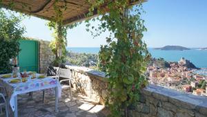 a patio with a table and a view of the city at Miralunga Villetta Gialla in Lerici