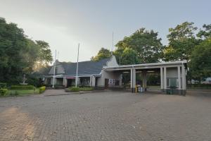 a building with a parking lot in front of it at ATKV Buffelspoort in Rustenburg