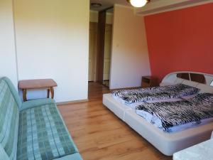 a room with a bed and a chair in it at Wieża nad Biebrzą in Dolistowo