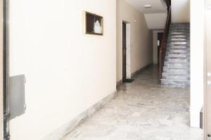 a hallway with a marble floor and stairs at B&B Porta Roma in Capua