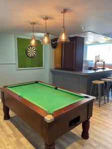 a kitchen with a pool table in a room at Waverley Hotel in Peterhead