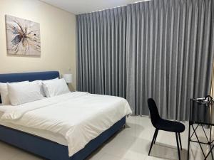 a bedroom with a bed and a chair next to a window at 3 Bed rooms Villa at Mina Alfajer Resort Dibba - Al-Fujairah in Rūl Ḑadnā