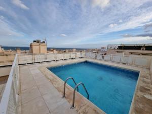 a swimming pool on the roof of a building at Apartamento Luz del Mediterraneo Garrucha in Garrucha