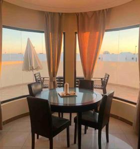 a dining room with a table and chairs and a large window at Riviera Park 7A - Air con- Wi-Fi- UK channels- 5 minutes walking from the sea in Tías