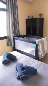 a bedroom with a bed with towels on it at Riviera Park 7A - Air con- Wi-Fi- UK channels- 5 minutes walking from the sea in Tías