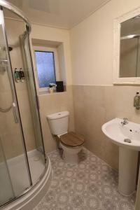 a bathroom with a toilet and a sink at Adlington Cottage, Lancashire in Adlington