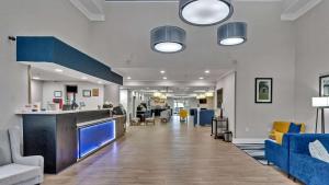 a large room with a lobby with blue furniture at Comfort Suites Salisbury I-85 in Salisbury