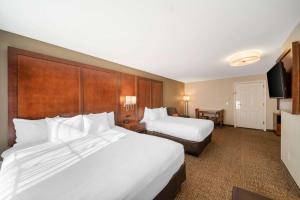a hotel room with two beds and a flat screen tv at Comfort Suites Red Bluff near I-5 in Red Bluff