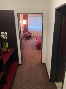 a hallway of a hotel room with a mirror at Hotel Villa Sophia in Warendorf