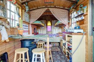 a kitchen with stools and a counter in a train room at Glamping Wagon - 1 x Double Bed 2 x Single Bed in Scarborough