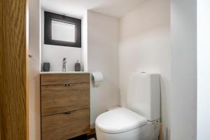 a bathroom with a white toilet and a sink at Casa da Praia, 2min de la PLAGE, hyper centre in Machico