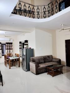 a living room with a couch and a table at Guruvayoor Homestay in Trichūr