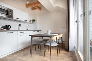 a kitchen with a table and chairs in a room at Schoenhouse City Street in Berlin