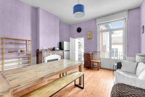 uma sala de estar com uma mesa de madeira e uma lareira em Rare pearl very quiet and bright in Toulouse em Toulouse