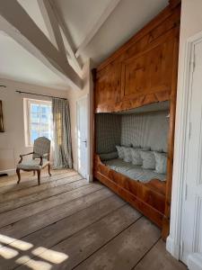 a bedroom with a bunk bed and a chair at Château du Tertre in Arsac