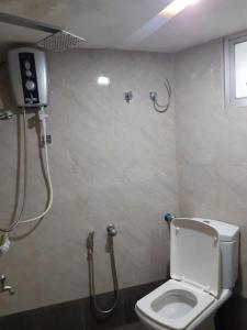 a bathroom with a toilet and a shower at River Valley in Weligama