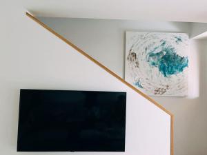 A television and/or entertainment centre at Meloneras Garden Suite