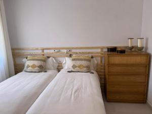A bed or beds in a room at Meloneras Garden Suite