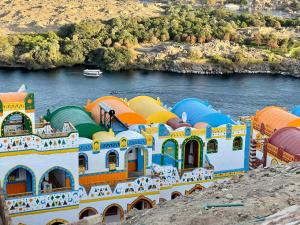 a large building on the side of a river at Kato Dool Wellness Resort in Aswan