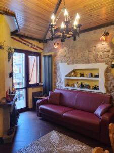 a living room with a couch and a stone wall at Stella D'Abruzzo in Roccaraso