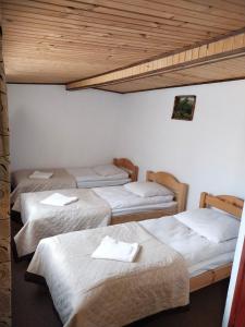 a group of four beds in a room at Ra in Bukovel