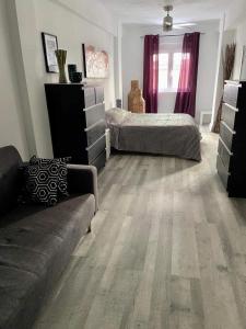 a living room with two beds and a couch at Rainbow Rentals Marques 7 in Benidorm